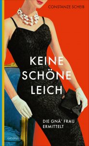 Cover von “Keine schöne Leich”: Grafik, deren Stil an 60,70er Jahre Zeitschriften erinnert. Eine Frau in schwarzem Cocktailkleid, mit weißen Handschuhen, Perlenkette, Clutch und hochgesteckten Haaren lehnt an einem türkisen Fauteuil. Der Hintergrund ist rot gehalten. Darüber in weißer Schrift: Keine schöne Leich - Die gnä’ Frau ermittelt - Oktopus In der oberen Ecke in schwarzer Schrift: Constanze Scheib